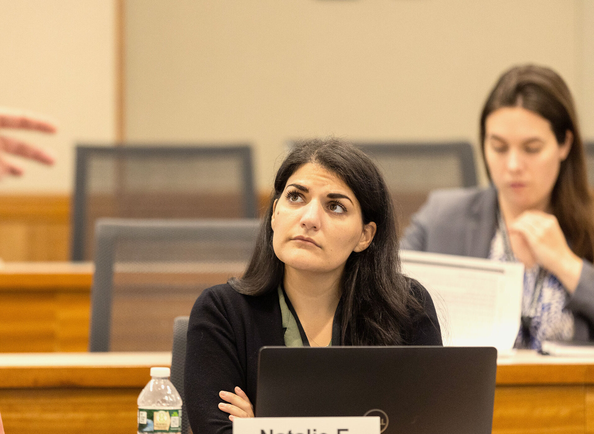 Woman looking thoughtful during a presentation.