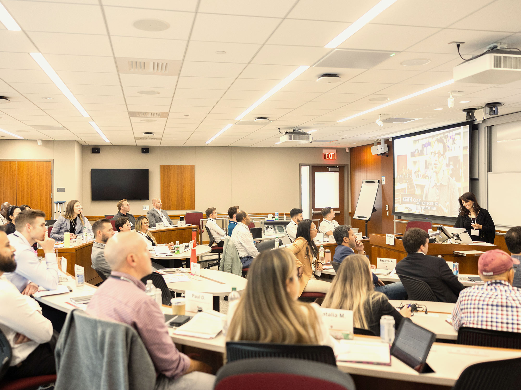 Instructor presenting to a classroom full of professionals.