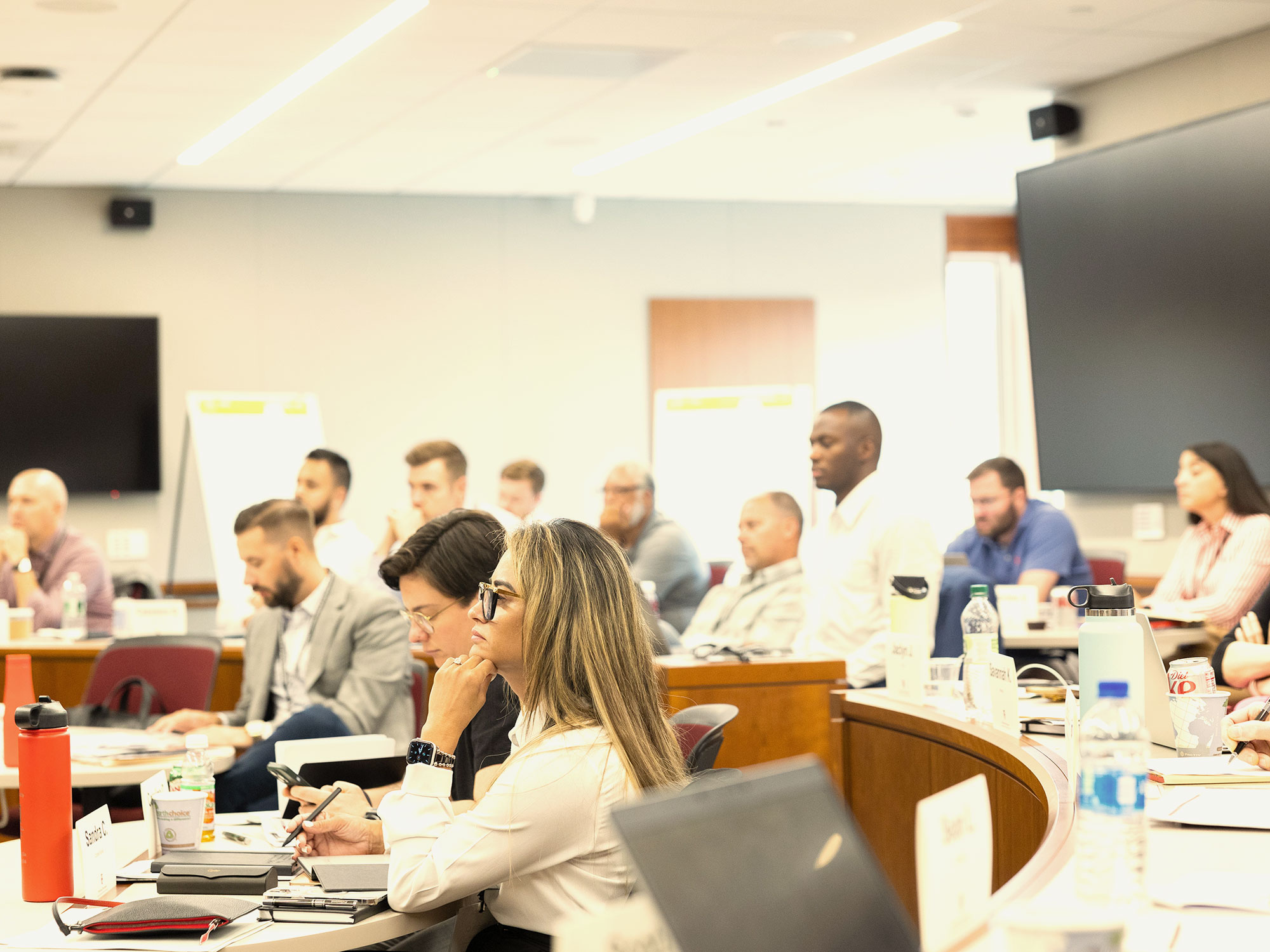 Professionals focused during a classroom-style lecture.