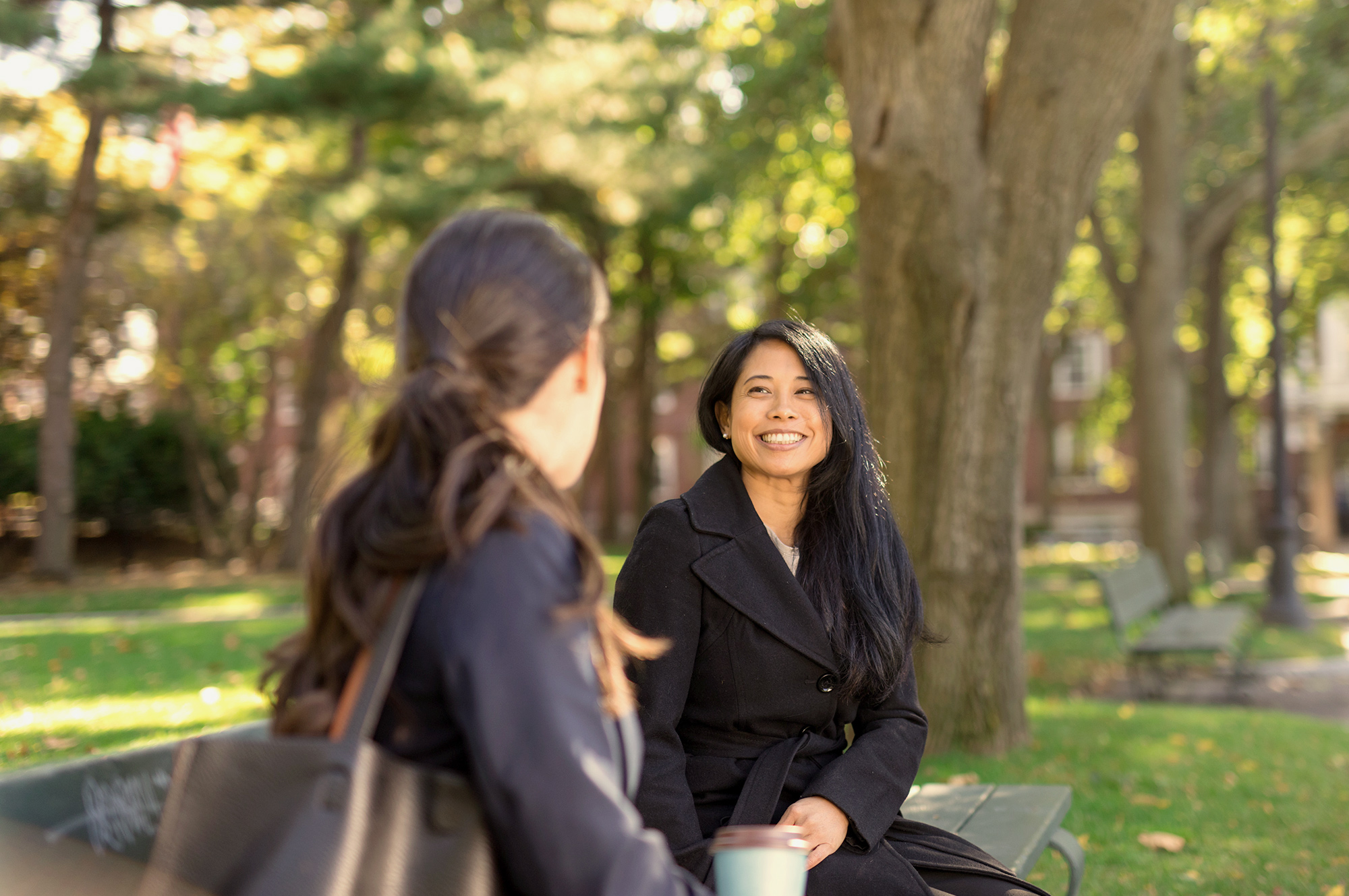 Gender diversity. Two professional women sitting outside talking