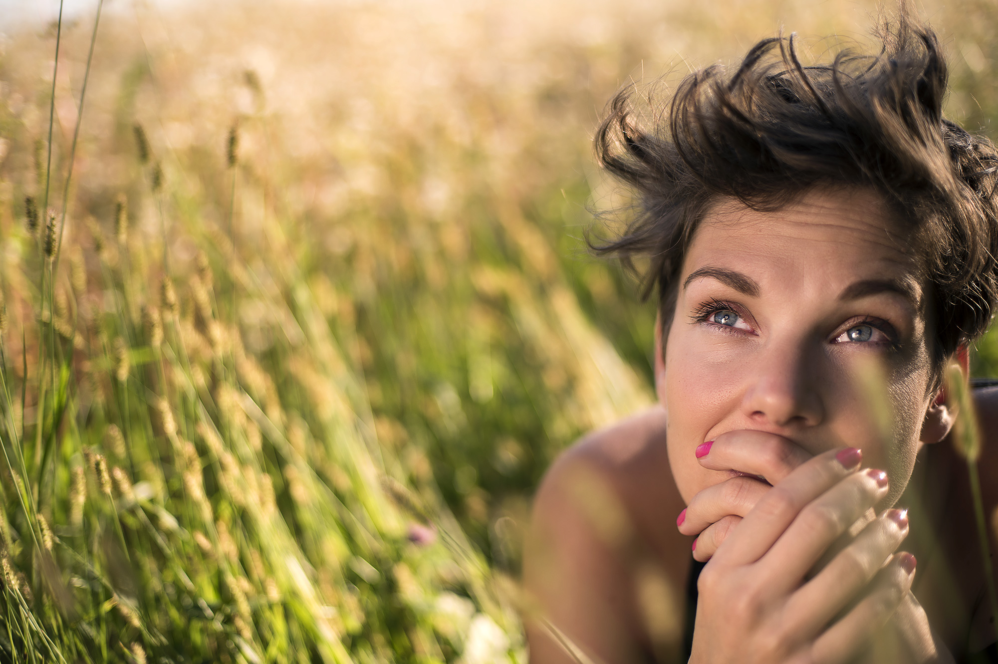 woman in field reflecting and thinking